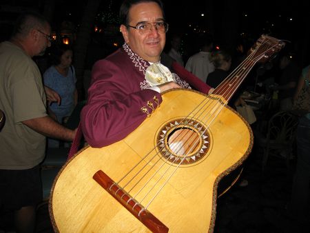 Strolling guitarronist  beginning a long night